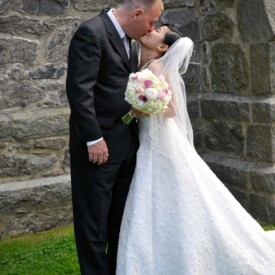 Bride and groom kissing outside the church
